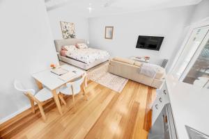 a living room with a couch and a table at Cromwell Lite in Cooma