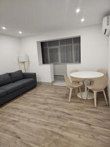 a living room with a couch and a table and chairs at Trusted Home in Târgovişte