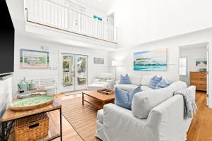 a living room with two couches and a table at Sugar in Santa Rosa Beach