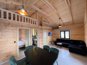 a living room with a black table and chairs at Kozara Panoramic Resort in Bosanska Gradiška