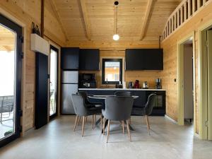 a kitchen and dining room with a table and chairs at Kozara Panoramic Resort in Bosanska Gradiška