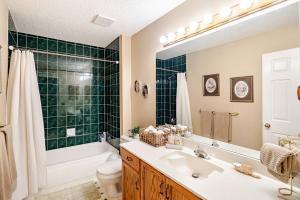 a bathroom with a sink and a tub and a toilet at Charming Victorian Home in Okotoks Elegant Comfort Modern Convenience in Okotoks +62 photos