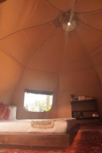 a room with a bed and a window in a tent at The Silkroad Mũi Né in Ấp Khánh Phước (1) +20 photos