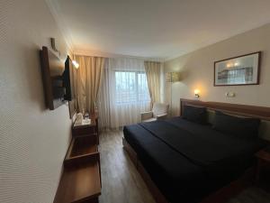 a hotel room with a bed and a window at Hotel Villa Marina in Bandırma +54 photos