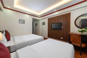 a hotel room with two beds and a television at Viet Hotel in Hanoi +38 photos