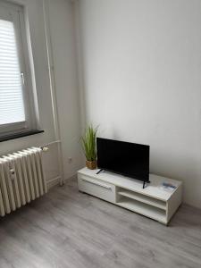a living room with a flat screen tv on a stand at Red Dot Apartment Lucky in Kamen