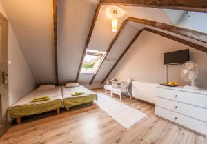a bedroom with a bed and a dresser in a attic at Domek pod Grabami in Gdańsk