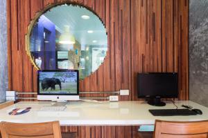 a desk with a computer and a monitor on it at Memory Patong - SHA Certified in Patong Beach