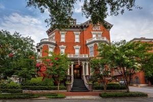a large red brick building with stairs in front of it at Kehoe House, Historic Inns of Savannah Collection in Savannah