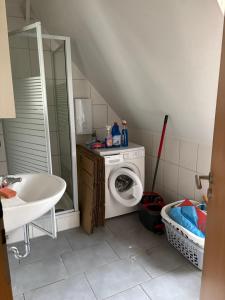 a bathroom with a washing machine and a sink at Red Dot Apartment Lucky in Kamen