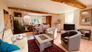 a living room with couches and a dining room at Villa L'Hermitière - 4 étoiles in Oytier-Saint-Oblas