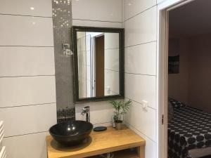 a bathroom with a bowl sink and a mirror at Villa L'Hermitière - 4 étoiles in Oytier-Saint-Oblas +20 photos
