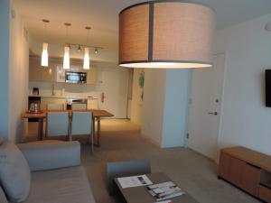 a living room with a table and a dining room at Beach Walk Resort Lux Apartment in Hollywood