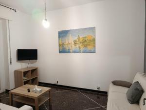 a living room with a couch and a picture on the wall at Via Roma 48 in Arquata Scrivia