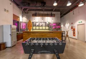 a ping pong table in the middle of a room at Em Oi Boutique Hotel in Nha Trang +68 photos