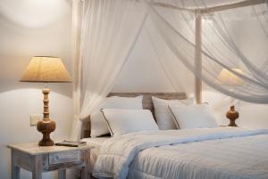 a bedroom with a bed with a canopy at Casa18Villa in Kiribathgoda +5 photos