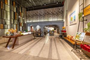 a large room with a hallway with tables and chairs at Em Oi Boutique Hotel in Nha Trang