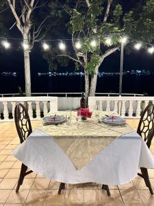 a table with chairs and a white tablecloth on it at Seaside Villa in Dauis
