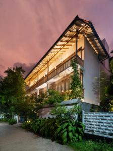 a house with a lit up facade at night at Casa18Villa in Kiribathgoda