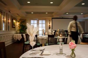 a dining room with a table with white table cloth at The Marshall House, Historic Inns of Savannah Collection in Savannah