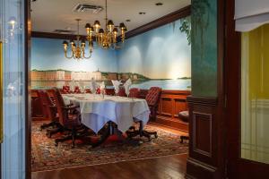 a dining room with a table and a painting on the wall at The Marshall House, Historic Inns of Savannah Collection in Savannah