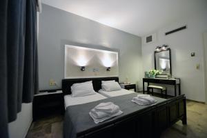 a bedroom with a bed with towels on it at Hotel Anna Apartments in Kokkini Khanion