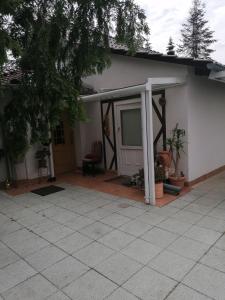 a house with a patio with a sliding door at Kleines Haus im Oderbruch in Neutrebbin