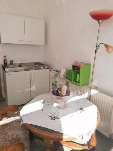 a small kitchen with a table with a lamp and a table sidx sidx sidx at Kleines Haus im Oderbruch in Neutrebbin