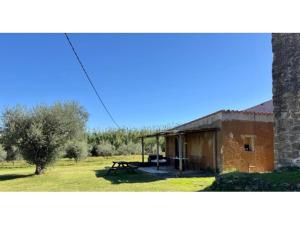 a building with a picnic table in front of it at La Caseta del Mas Valls in Rupiá