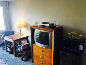 a hotel room with a tv on a dresser at Flagship Inn in Bremerton