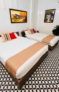 a couple of beds in a room at Old Quarter Lake House in Hanoi