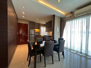 a dining room and kitchen with a table and chairs at The Villa Jomtien Pattaya By Ahmed in Jomtien Beach