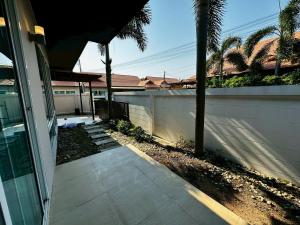 a sidewalk next to a house with a fence at The Villa Jomtien Pattaya By Ahmed in Jomtien Beach
