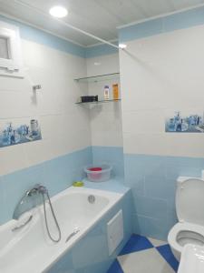 a blue and white bathroom with a tub and a toilet at l'Abrit tranquille 3 in Tefeschoun +43 photos