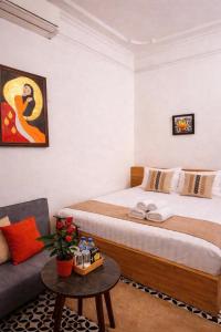 a hotel room with a bed and a couch at Old Quarter Lake House in Hanoi