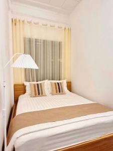 a bedroom with a large white bed with pillows at Old Quarter Lake House in Hanoi