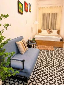 a living room with a blue couch and a bed at Old Quarter Lake House in Hanoi +50 photos
