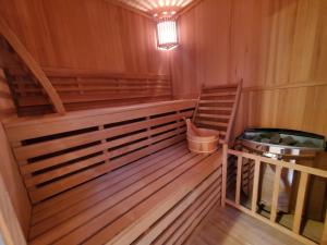 a sauna with a wooden floor and a ladder in it at Au Moulin du Miech in Salvagnac +34 photos