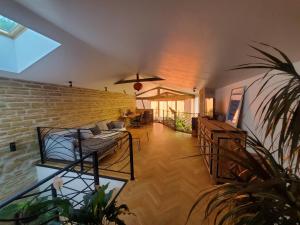 a living room with a brick wall at Au Moulin du Miech in Salvagnac