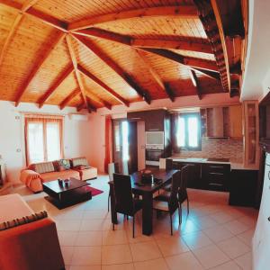 a large living room with a table and chairs at Apartments Polonia Saranda in Sarandë