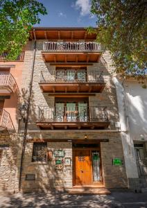 a brick building with a balcony and a door at Casa Rural Teresa in Libros