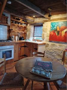 a kitchen with a wooden table in a room at Gite A'mour Charlannes in Hautefage