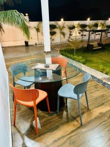 a patio with chairs and a table and a table and chairs at Sandhika Retreat in Varanasi