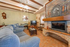 a living room with a blue couch and a fireplace at Casa Rural Teresa in Libros