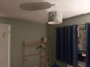 a bathroom with a ceiling fan and a shower curtain at 40 Hirst Grove in Hebden Bridge