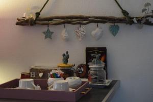 a shelf with dishes and other items on a wall at Gite le GINKGO 50 M2 in Rougegoutte +41 photos