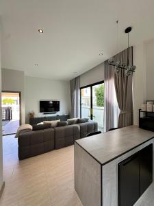 a living room with a couch and a table at 2 Bedroom Modern House in Ban Nong Chaeng