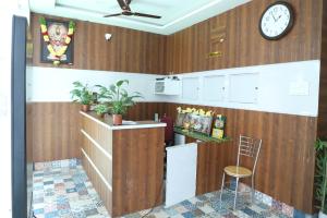 a room with a counter and a clock on the wall at Hill Woods Yelagiri in Yelagiri