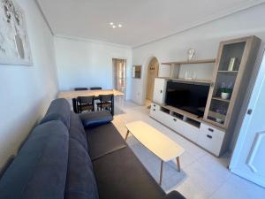 a living room with a couch and a table at Chalet La Mata in Torrevieja