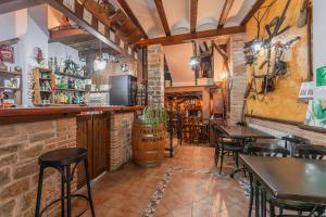 a bar with tables and chairs in a restaurant at Casa Rural Teresa in Libros